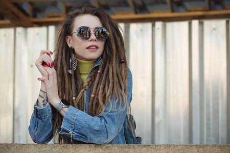 Stylish woman with dreadlocks, fashion portrait in cityの写真素材