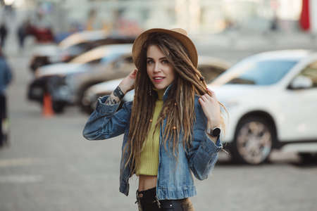 Street style, stylish woman with dreadlocks walking in cityの写真素材