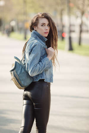Portrait of fashionable woman with dreadlocks keep bag