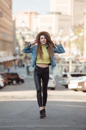 Street style, fashionable woman walking in city on roadの写真素材