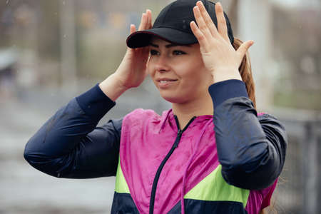Sports woman portrait in rainy dayの写真素材