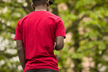 Trendy, cropped shot of black man in pink t-shirt, back viewの写真素材
