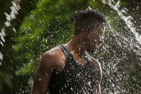 Fresh water splash pouring on a man, spa and health conceptの写真素材