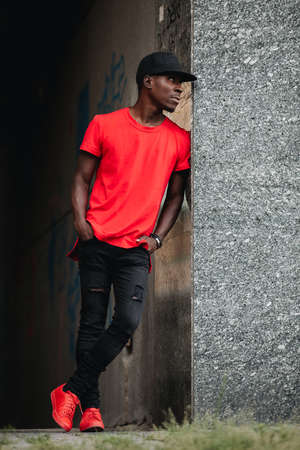 African man in red t-shirt at urban city place