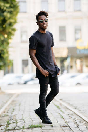 Young african man wearing black t-shirt in city streetの写真素材