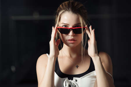 Glamorous luxury woman puts on pink eyewear