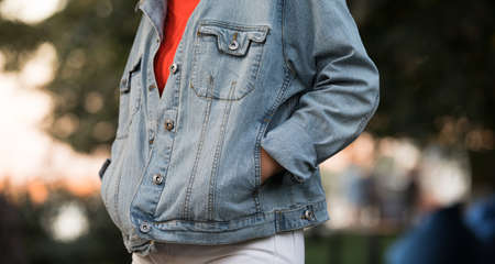 Cropped of unrecognizable woman wear denim jacket, hands in pocketsの写真素材