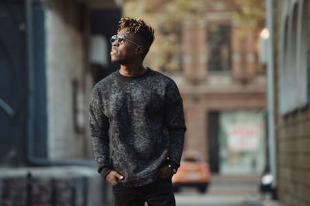 Fashionable cool stylish african american man walking in urban territoryの写真素材