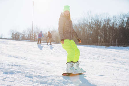 Winter sport activity, woman snowboarder ridingの写真素材