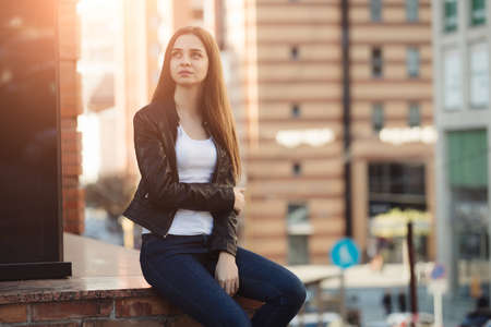 Woman sitting in urban city street