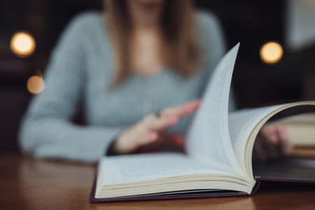 Woman turn pages in the book close upの写真素材