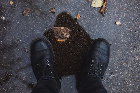 Black boots in the puddleの写真素材