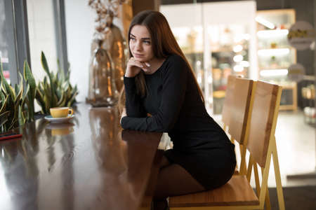 Portrait of pretty woman sitting in cafe