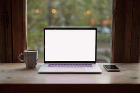Blank empty screen of laptop in cafe at the windowの写真素材