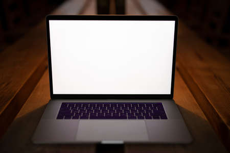 Blank empty screen of laptop in cafe on a table