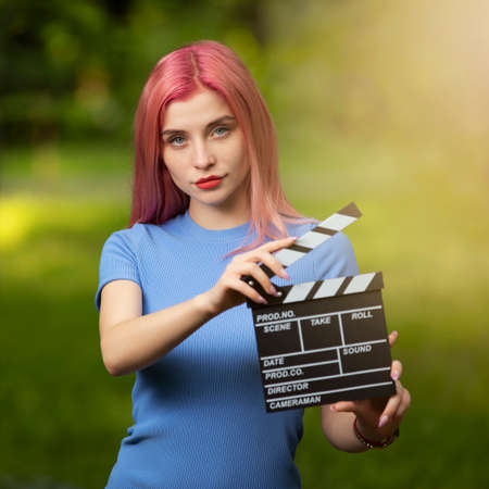 Assistant of director holding movie flapper, professional filming