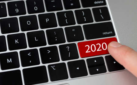 Press 2020 red button on PC keyboard, looking at futureの写真素材