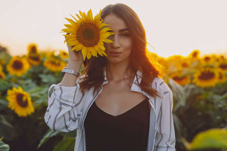 Funny woman portrait in sunflower field