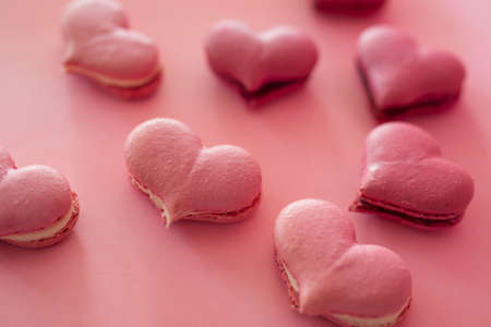 Many pink macaroons in the heart shapeの写真素材