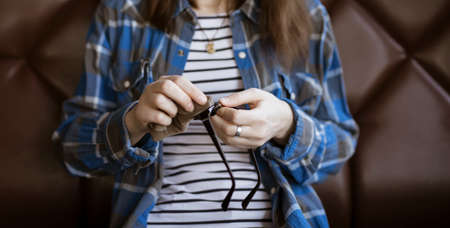 Female hands cleaning eyeglasses with microfiber clothの写真素材