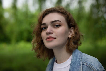 Beautiful woman face closeup portrait on green natureの写真素材