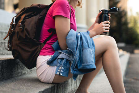 Unrecognizable student woman sittingの写真素材