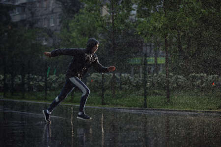 Man jogging under rain, flash light