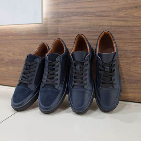 Collection of dark blue suede and leather sneakers in the shoes store