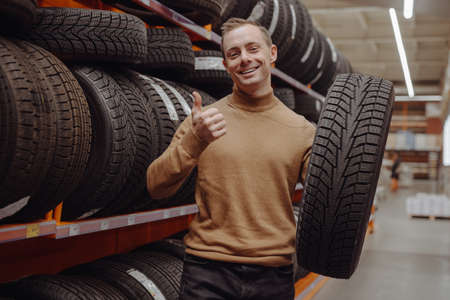Man chooses winter car tires in the auto shopの写真素材