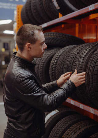 Man chooses winter car tires in the auto shopの写真素材