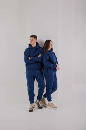 Couple posing in studio wearing blue hoodie costumesの写真素材