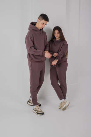 Couple posing in studio wearing brown hoodie costumesの写真素材
