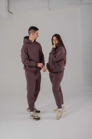 Couple posing in studio wearing brown hoodie costumesの写真素材