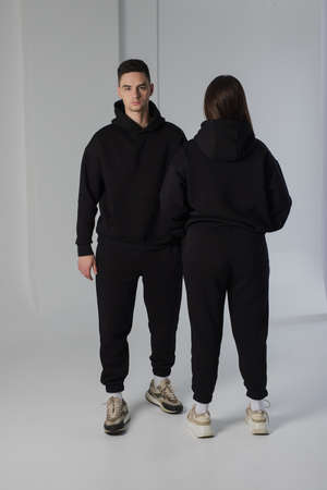Couple posing in studio wearing black hoodie costumesの写真素材