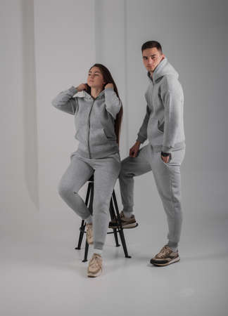 Couple posing in studio wearing gray hoodie costumesの写真素材
