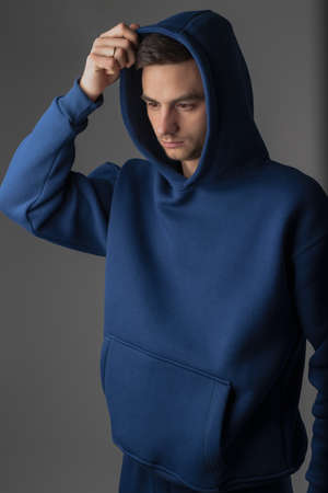 Man posing in studio wearing blue hoodie costumesの写真素材