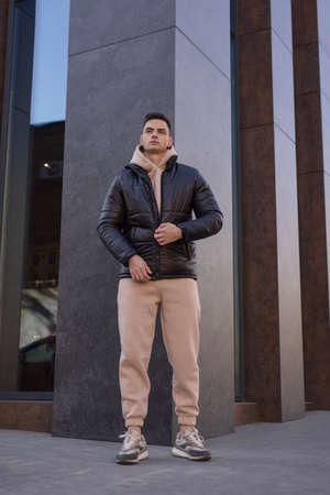 Man posing in city wearing black winter jacketの写真素材