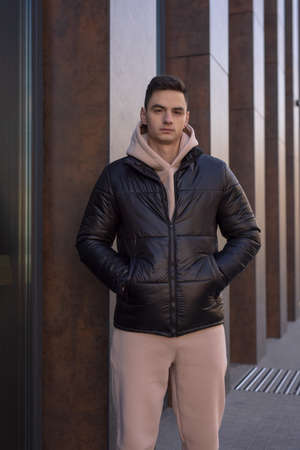 Man posing in city wearing black winter jacketの写真素材