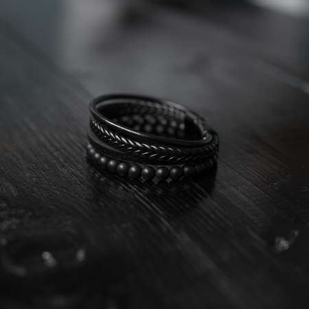 Black leather male bracelet on the dark wooden deskの写真素材