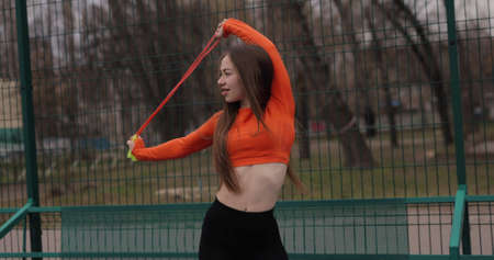 Sporty sexy woman holding a skipping rope in a parkの写真素材
