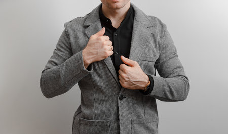 Unrecognizable man in classical suit at grey backgroundの写真素材