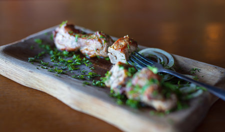 Pork meat on the wooden plate in restaurantの写真素材