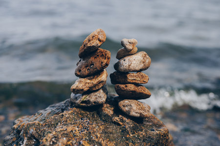 Stack of stones balancing against the sea backgroundの写真素材