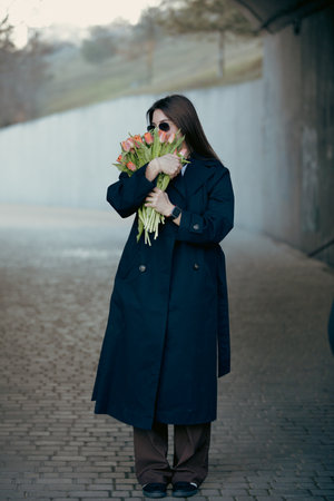 Happy woman sniff flowers in the tunnel at the spring dayの写真素材