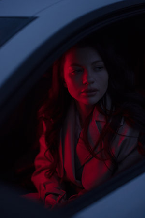 Portrait of woman in the car with red light