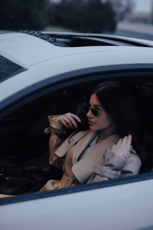 Pretty woman sitting and posing in a luxury carの写真素材