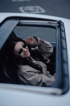 Pretty woman sitting and posing in a luxury carの写真素材