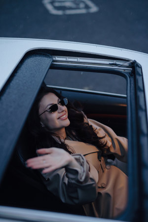 Pretty woman sitting and posing in a luxury carの写真素材