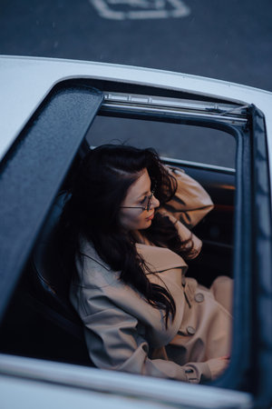 Pretty woman sitting in a luxury carの写真素材