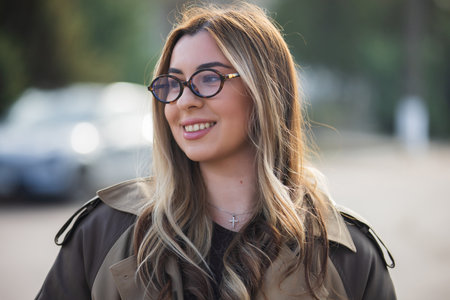 Pretty smiling woman in eyeglasses, city portrait close-upの写真素材